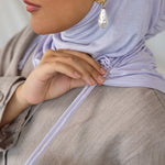 Model wearing Soft Amethyst Ruching Lite, showing soft purple shade and structured drape.