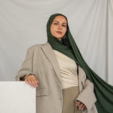 Model wearing Hunter Green Jersey Lite styled in a loose wrap, showcasing its stretchy, wrinkle-resistant drape.