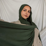 Model wearing Hunter Green Jersey Lite styled in a loose wrap, showcasing its breathable, wrinkle-resistant drape.
