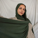 Model wearing Hunter Green Jersey Lite styled in a loose wrap, showcasing its breathable, wrinkle-resistant drape.