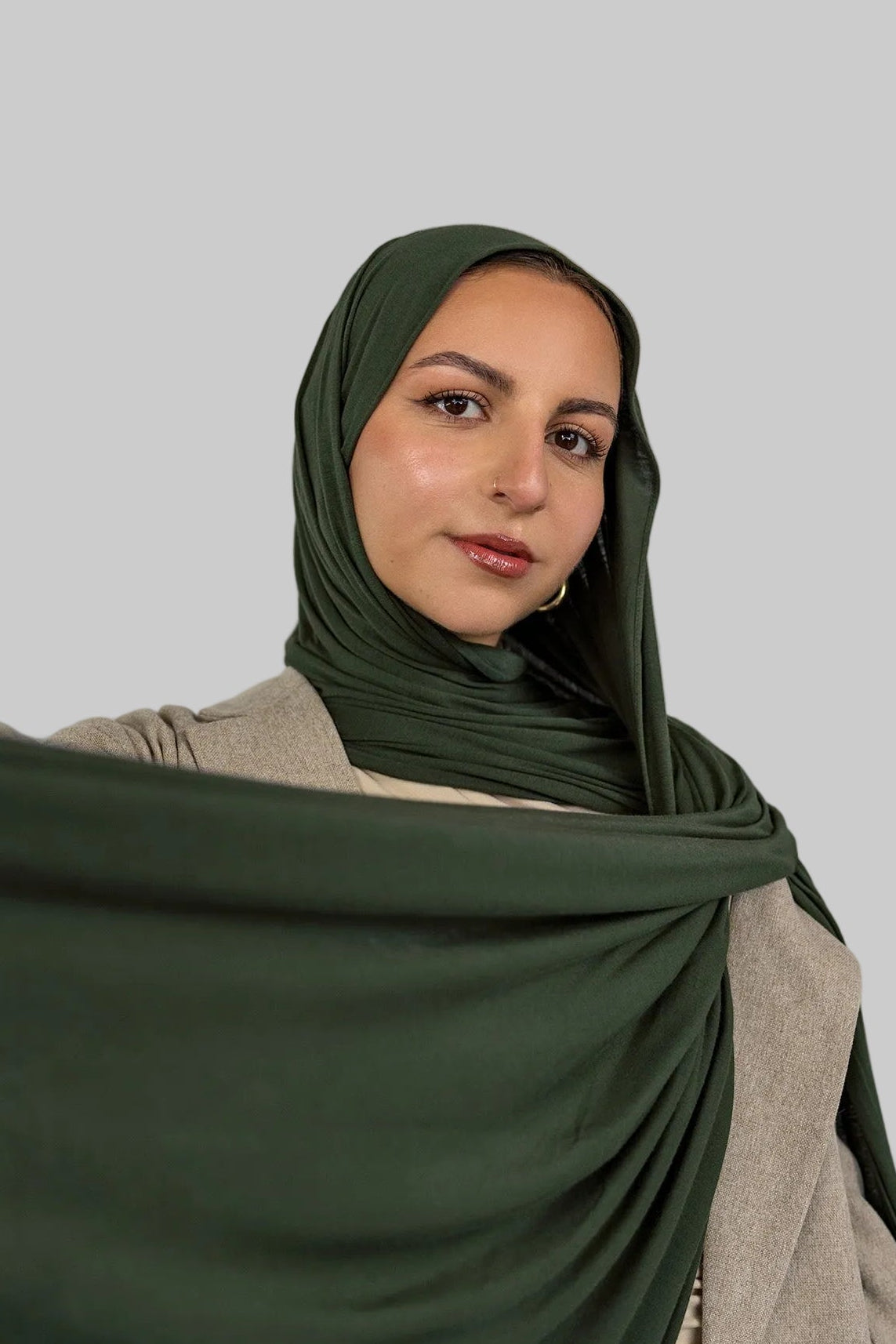 Model wearing Hunter Green Jersey Lite styled in a loose wrap, showcasing its breathable, wrinkle-resistant drape.