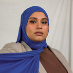 Model wearing Ocean Blue Jersey Lite in a casual wrap style, showing off its breathable, wrinkle-resistant fabric.
