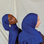 Two models wearing Ocean Blue Jersey Lite, one looking out and one front facing displaying its deep, saturated blue in different angles.