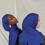 Two models wearing Ocean Blue Jersey Lite, one looking out and one front facing displaying its deep, saturated blue in different angles.