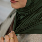 Close-up of model stretching her Hunter Green Ruching Lite.