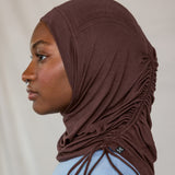 Model wearing Espresso Ruching Lite highlighting the ruched detail from the side profile. 
