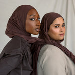 Two models wearing Espresso Jersey Lite, demonstrating its malleable nature and rich chocolate color.