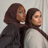Two models wearing Espresso Jersey Lite, demonstrating its malleable nature and rich chocolate color.