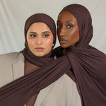Two models wearing Espresso Jersey Lite, demonstrating its stretch and rich hues. 