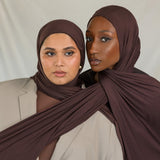 Two models wearing Espresso Jersey Lite, demonstrating its stretch and rich hues. 