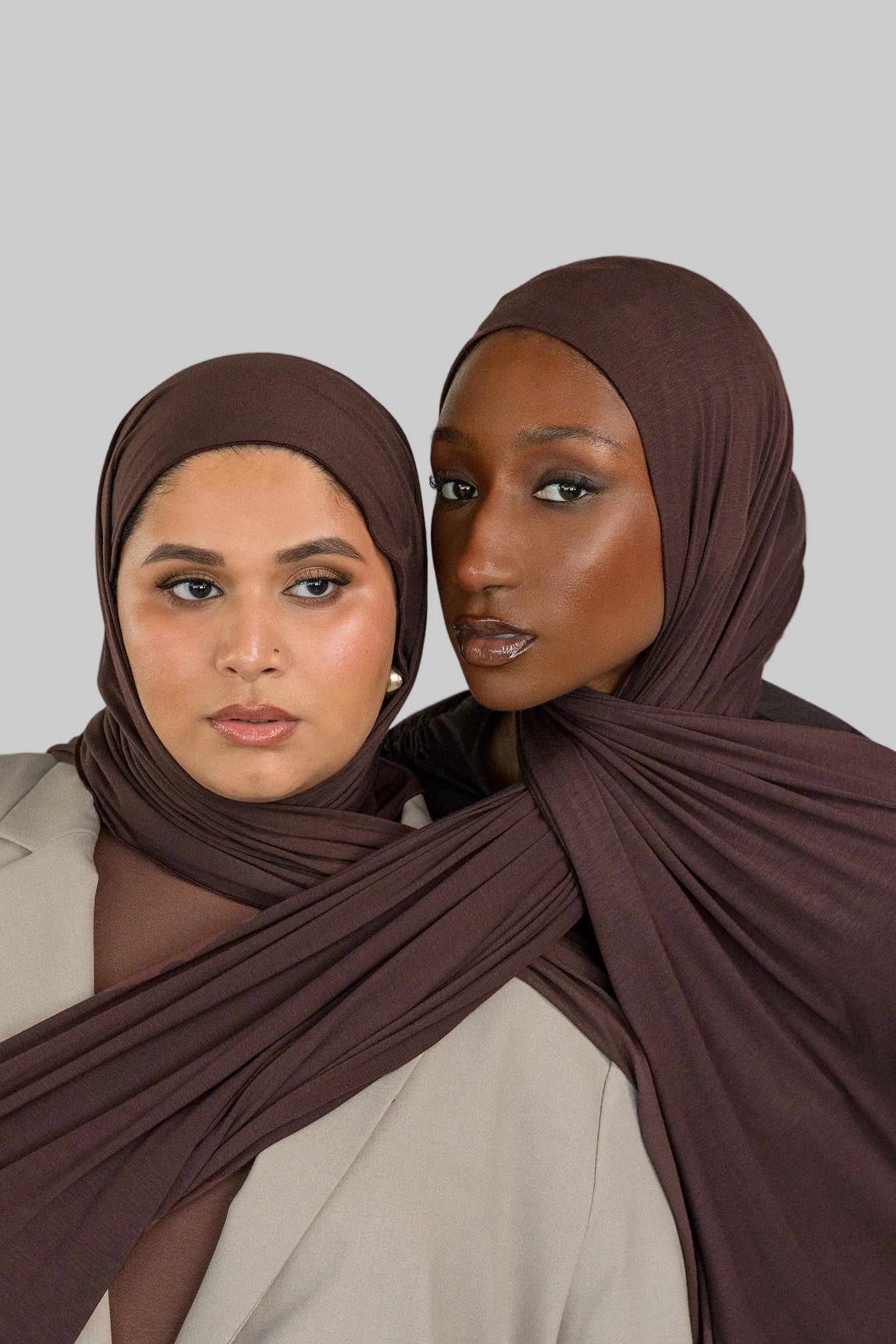Two models wearing Espresso Jersey Lite, demonstrating its stretch and rich hues. 