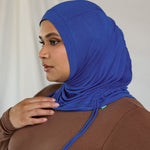 Model wearing Ocean Blue Ruching Lite with ruched edge framing the face, showing breathable fabric.