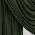 Close-up of Hunter Green Jersey Lite fabric draped smoothly against a white backdrop, showing its deep forest green tone and soft, lightweight texture.