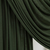 Close-up of Hunter Green Jersey Lite fabric draped smoothly against a white backdrop, showing its deep forest green tone and soft, lightweight texture.
