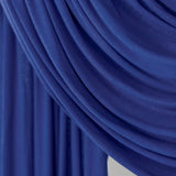 Ocean Blue Jersey Lite fabric draped in front of a white backdrop, revealing its bold indigo hue and featherlight jersey texture.