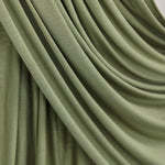 Palm Desert Jersey Lite fabric draped in front of white backdrop, revealing olive tone and airy jersey weave.