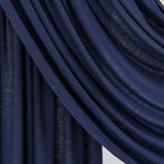 Twilight Blue Jersey Lite fabric swatch draped smoothly in front of a white backdrop, revealing its moody navy hue.