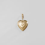 Gold heart-shaped pendant on a light gray background