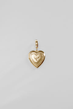 Gold heart-shaped pendant on a light gray background