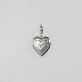 Silver heart-shaped pendant on a light gray background