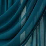Close-up of teal fabric with a draped effect