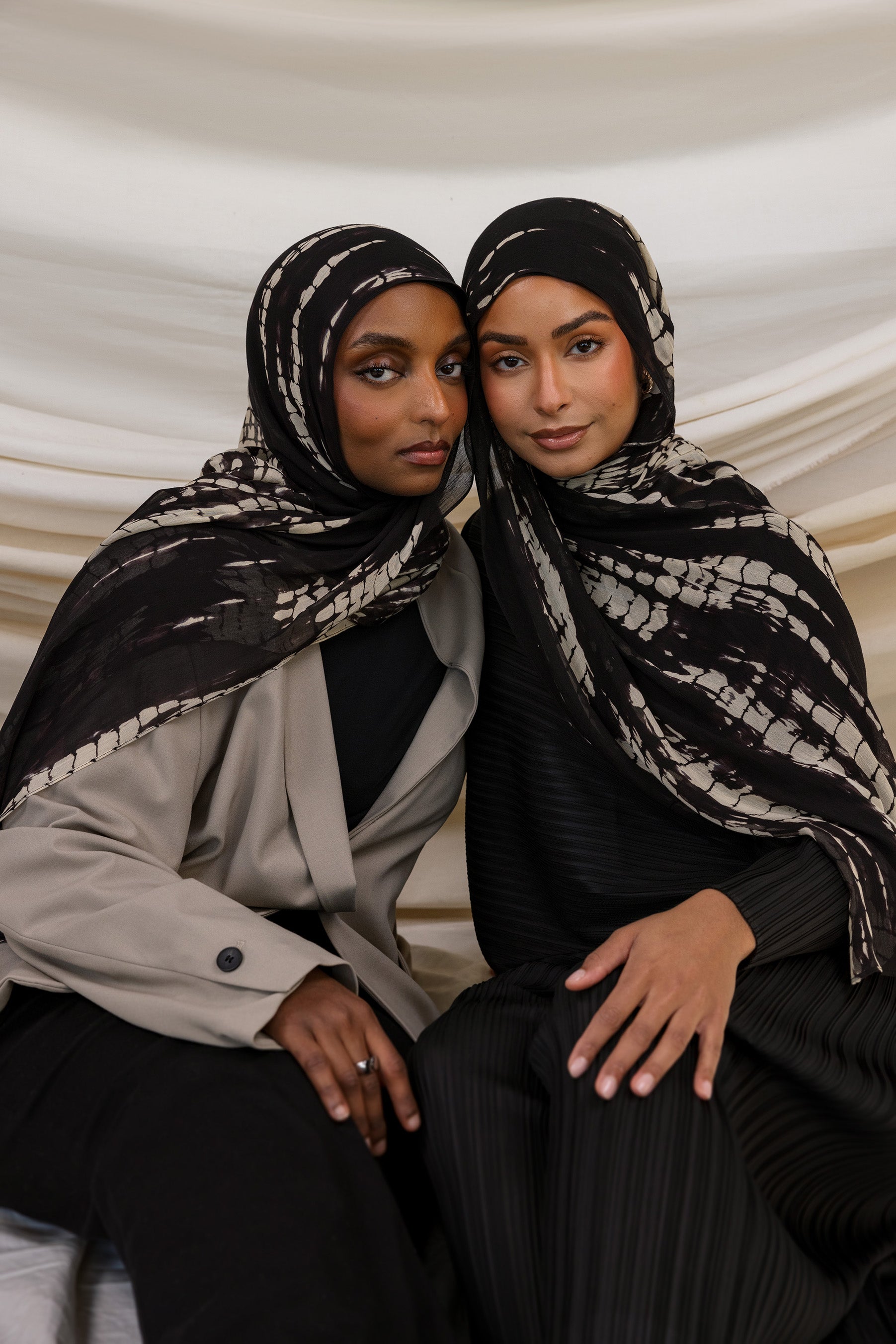 Two Models wearing ripple-textured hijab with flowing pattern and timeless, handmade charm.

