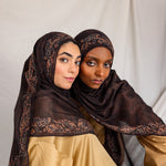 Two women posing in Chocolate Paisley hijabs, styled differently.