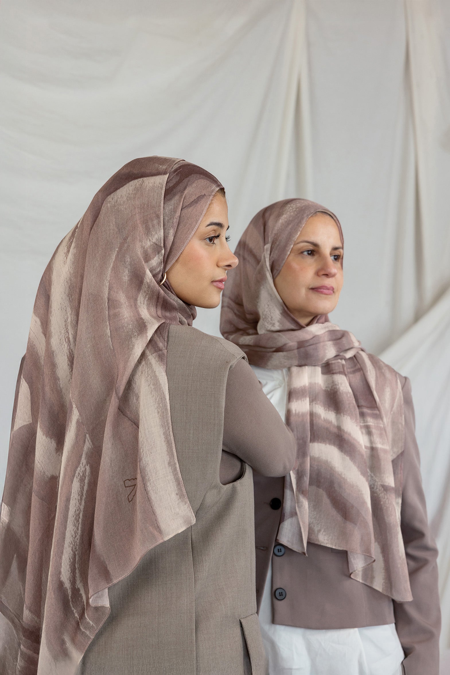 Two models wearing brown sediment printed hijabs