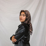 Model styled in a print silk hijab featuring leopard design. 