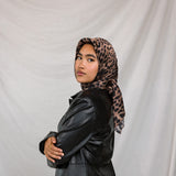 Model styled in a print silk hijab featuring leopard design. 