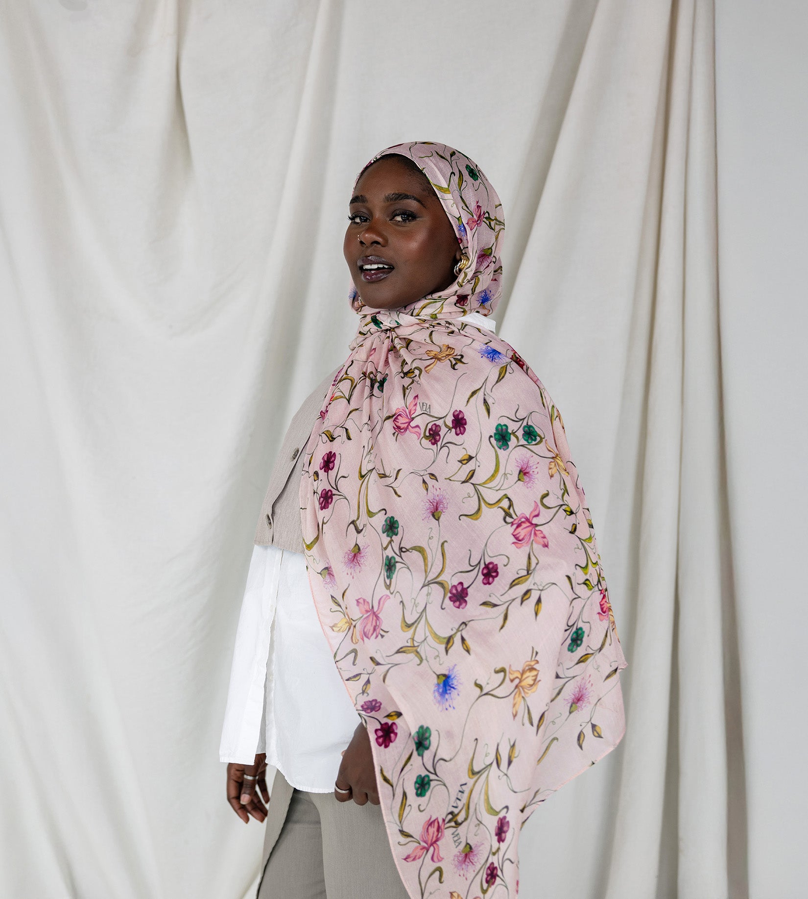 Model wearing ethically made hijab with a charming floral motif and effortless drape.

