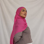 Model shown wearing Rose Wave, a bright and saturated pink scarf. 
