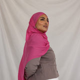 Model shown wearing Rose Wave, a bright and saturated pink scarf. 