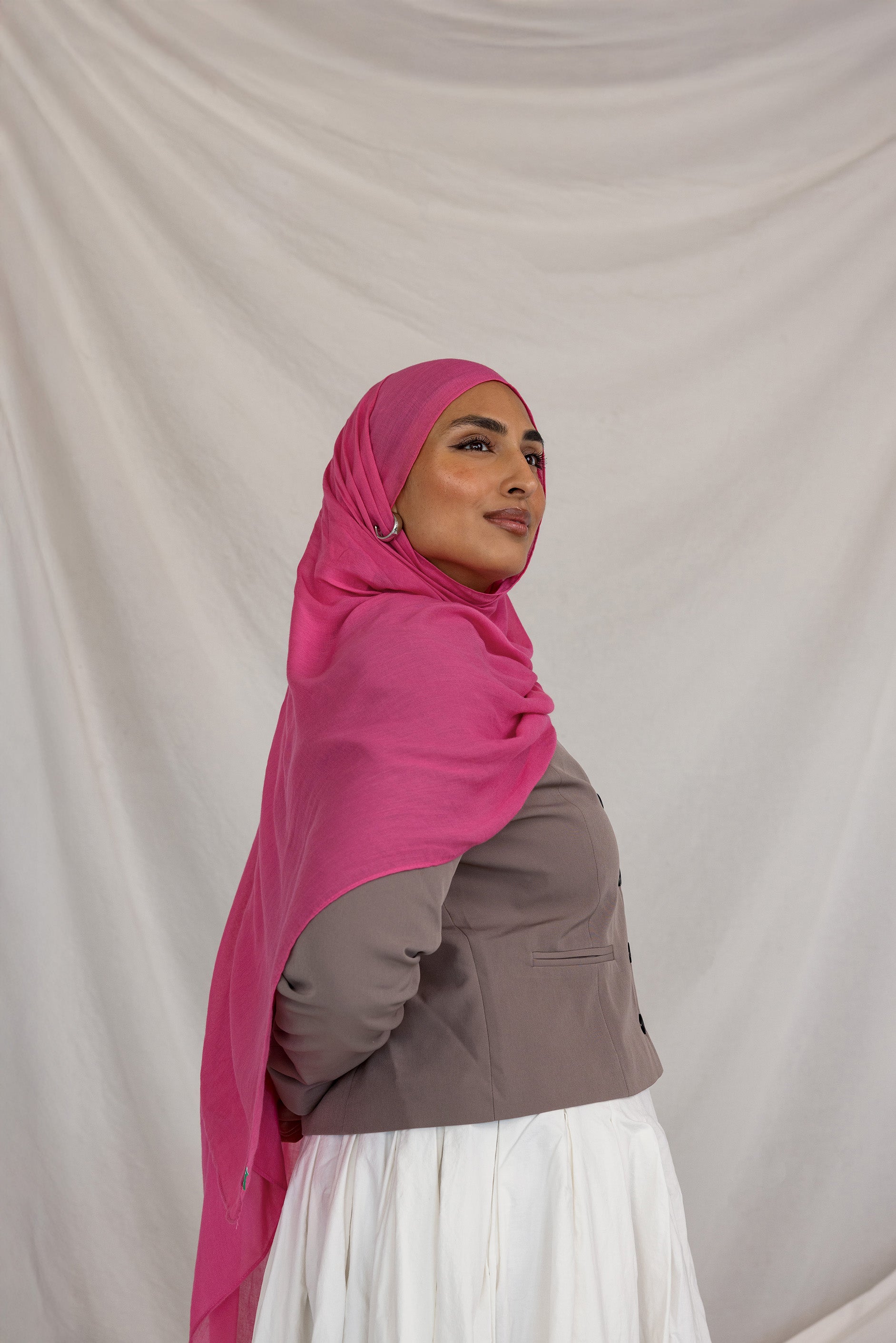 Model shown wearing Rose Wave, a bright and saturated pink scarf. 