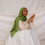 Model in three-quarter pose wearing the Fern Green hijab, emphasizing the fabric’s drape and flow.