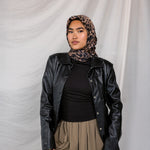 A leopard print silk hijab styled on a model.