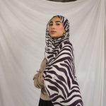 Model shown wearing the Zebra print by VELA, which features a white base and deep berry toned stripes. 
