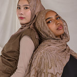Two models styled in Mocha Dunes patterned hijabs against a plain background.