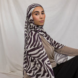 Model shown wearing VELA's Zebra print, which features deep berry toned stripes like a zebra, on a white base. 