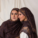Side profile shot of two women styled in Chocolate Paisley hijabs.