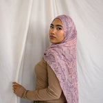 Model in VELA pink and purple snakeskin inspired print.