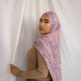 Model in VELA pink and purple snakeskin inspired print.