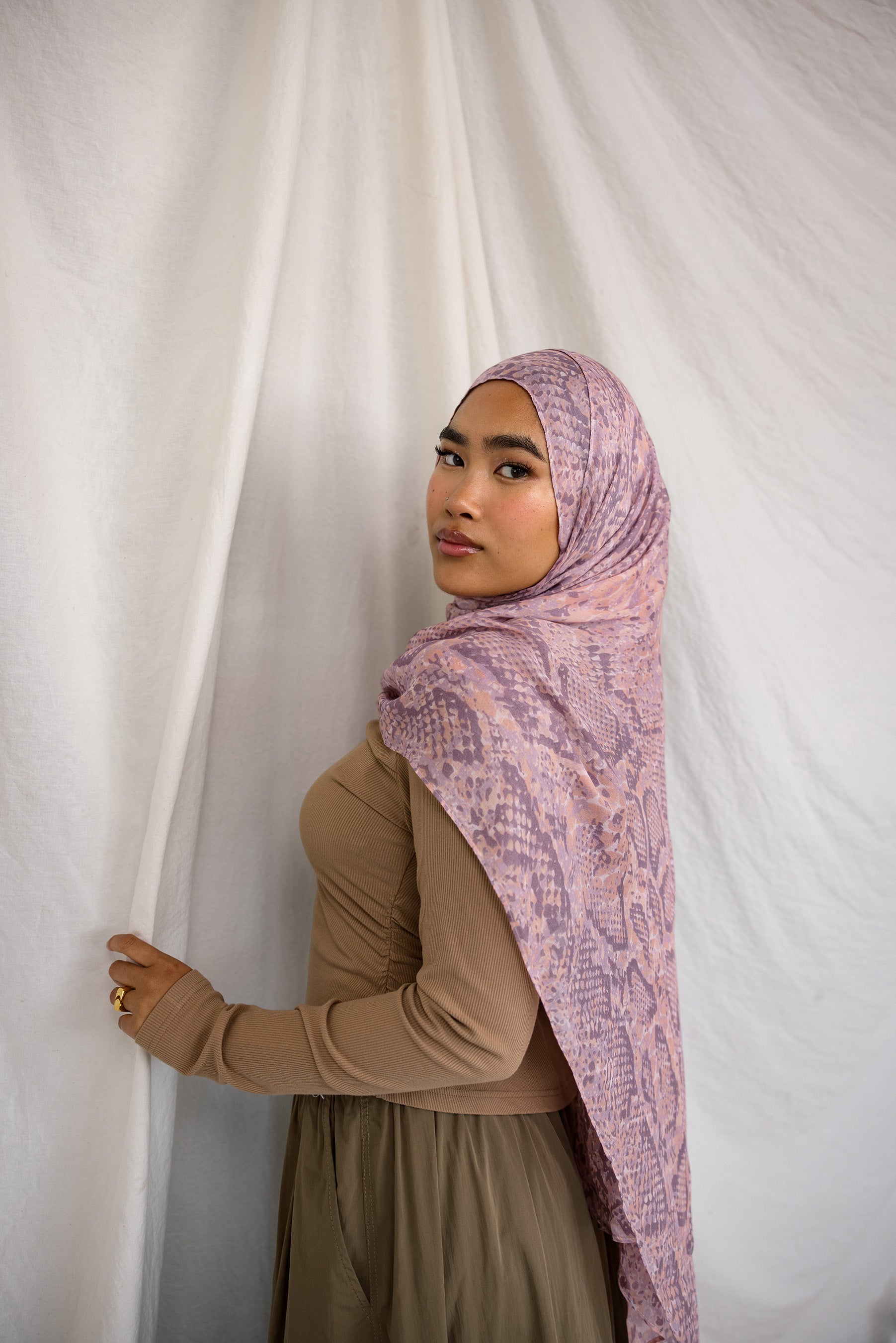 Model in VELA pink and purple snakeskin inspired print.