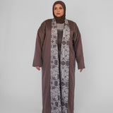 Woman wearing a long abaya with a hijab on a white background