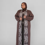 Woman wearing a brown abaya with a hijab on a white background