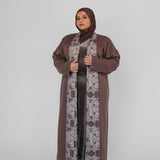 Woman wearing a brown abaya with a hijab on a white background