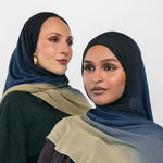 Two women wearing blue ombre hijabs with a neutral background