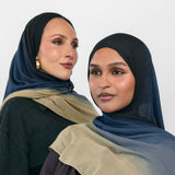 Two women wearing blue ombre hijabs with a neutral background