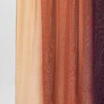 Ombre fabric swatch with colors transitioning from beige to brown to purple on a light gray background.