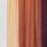 Ombre fabric swatch with colors transitioning from beige to brown to purple on a light gray background.
